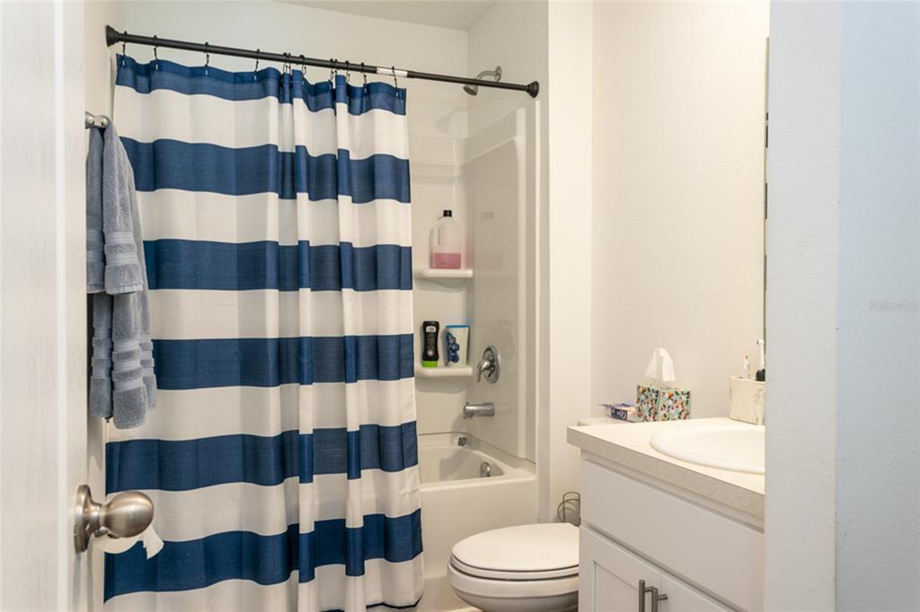 18 Bogey Place Bunnell, FL 32110 - Photo 18 of 40 a bathroom with a sink a toilet a shower curtain and a mirror