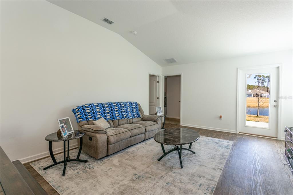 18 Bogey Place Bunnell, FL 32110 - Photo 3 of 40 a living room with furniture and a wooden floor