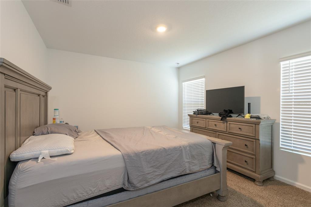 18 Bogey Place Bunnell, FL 32110 - Photo 4 of 40 a bedroom with a bed and a flat screen tv