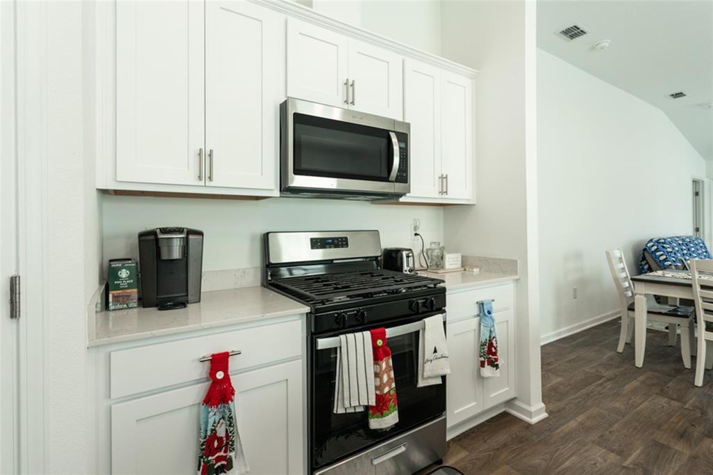 18 Bogey Place Bunnell, FL 32110 - Photo 8 of 40 a kitchen with stainless steel appliances a stove a microwave and cabinets