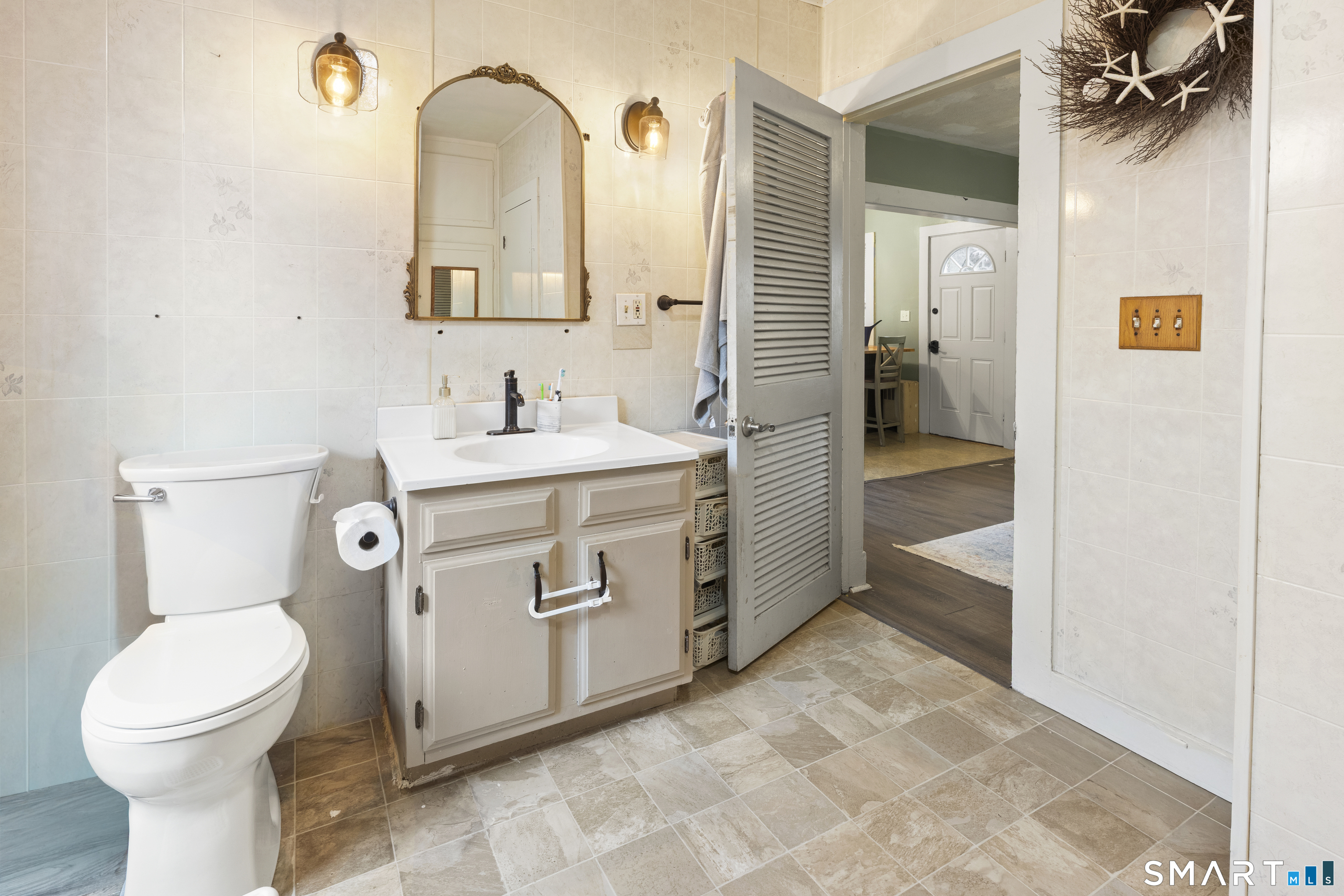 47 Broad Street Killingly, CT 06239 - Photo 15 of 33 a spacious bathroom with a toilet sink and mirror