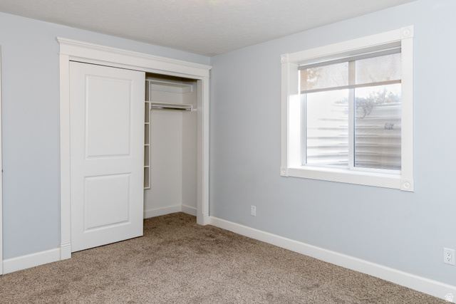 434 Cardon Ridge Drive Smithfield, UT 84335 - Photo 43 of 59 Unfurnished bedroom featuring a closet and light carpet