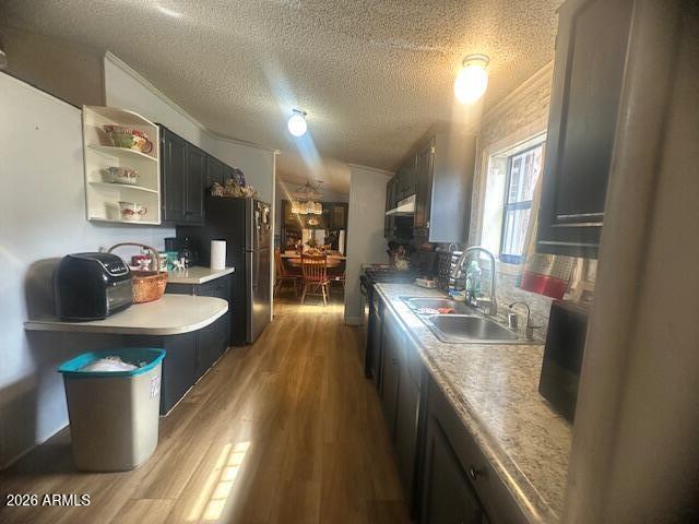 7258 South Lariat Road Hereford, AZ 85615 - Photo 8 of 37 a kitchen with stainless steel appliances granite countertop a sink a stove and wooden floor