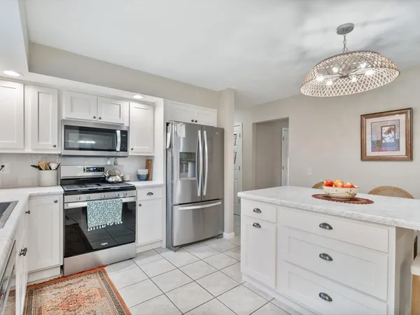 a room that has a dresser and a table in it