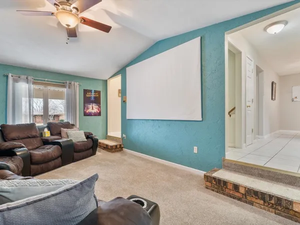 a spacious bedroom with a bed and ceiling fan