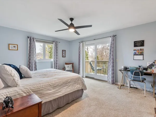 a bedroom with a large bed and a large window