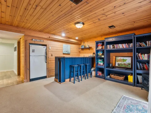 a living room with granite countertop furniture a rug and a chandelier