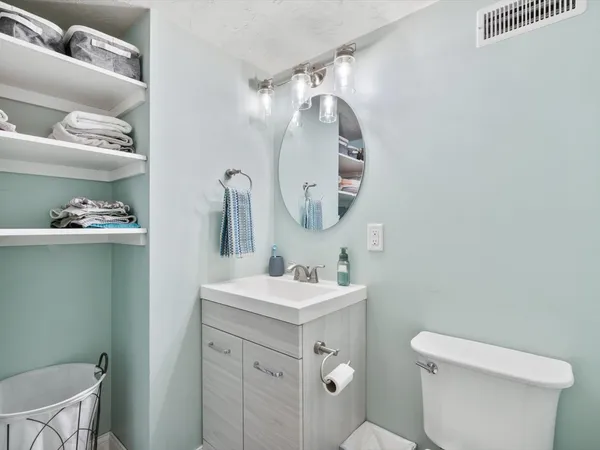 a roof deck with table and chairs and wooden floor