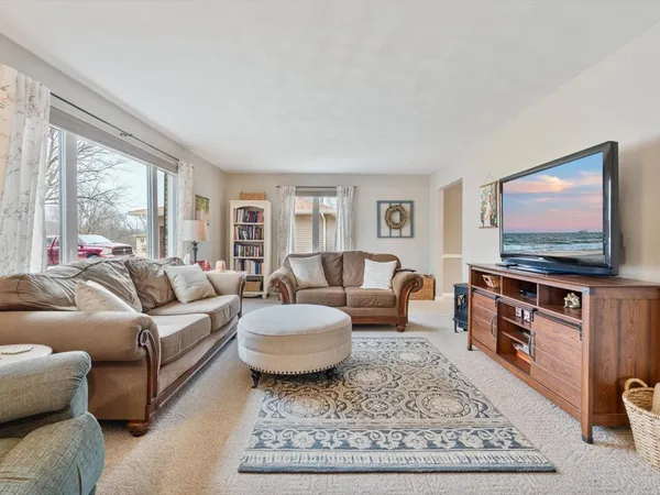 a living room with furniture a rug and a flat screen tv