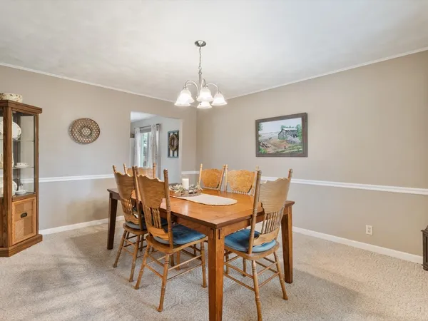 a view of a dining room with furniture and chandelier