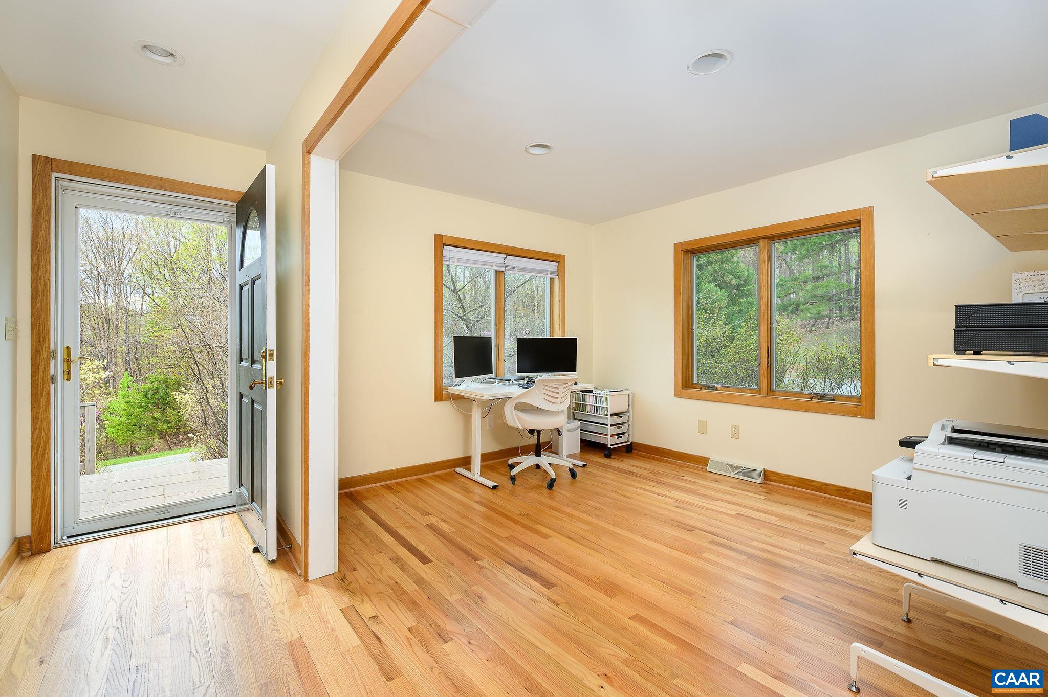 888 Wolf Trap Road Charlottesville, VA 22911 - Photo 13 of 63 a living room with a large window wooden floor table and chairs
