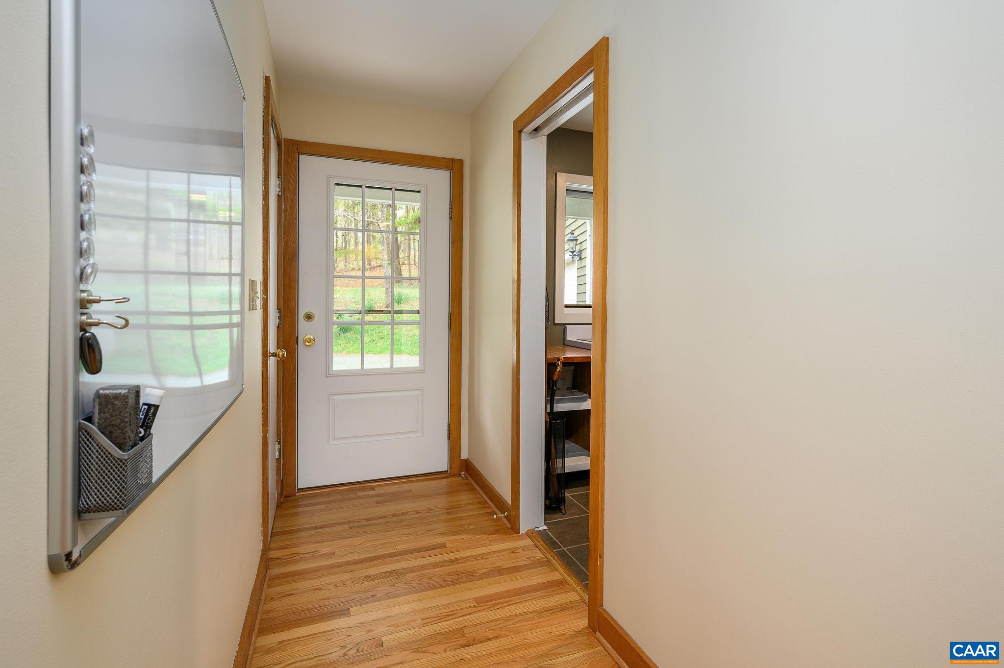 888 Wolf Trap Road Charlottesville, VA 22911 - Photo 16 of 63 a view of a hallway with wooden floor and a bathroom