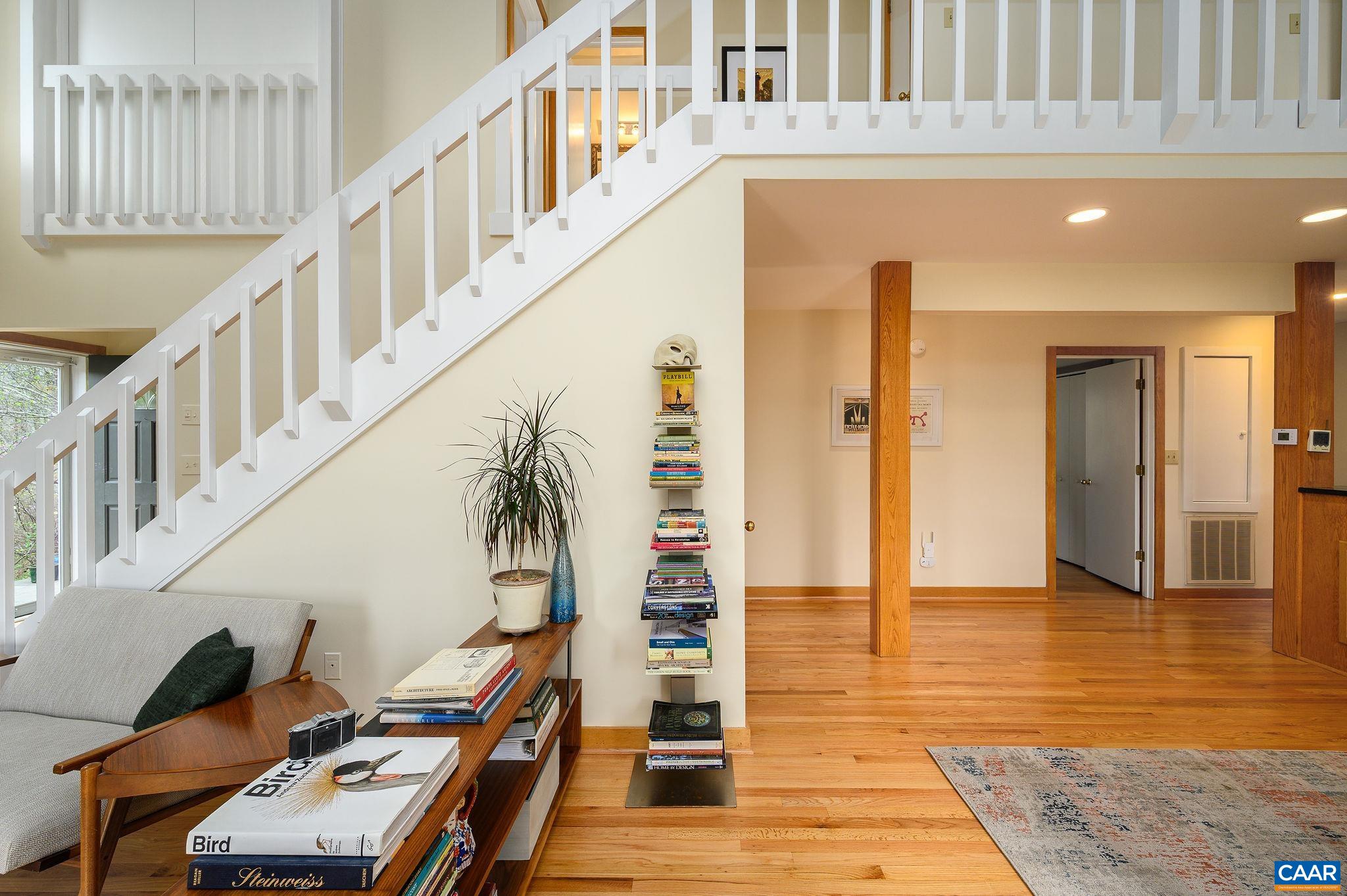 888 Wolf Trap Road Charlottesville, VA 22911 - Photo 19 of 63 a view of staircase with lots of frames on wall and a dining table
