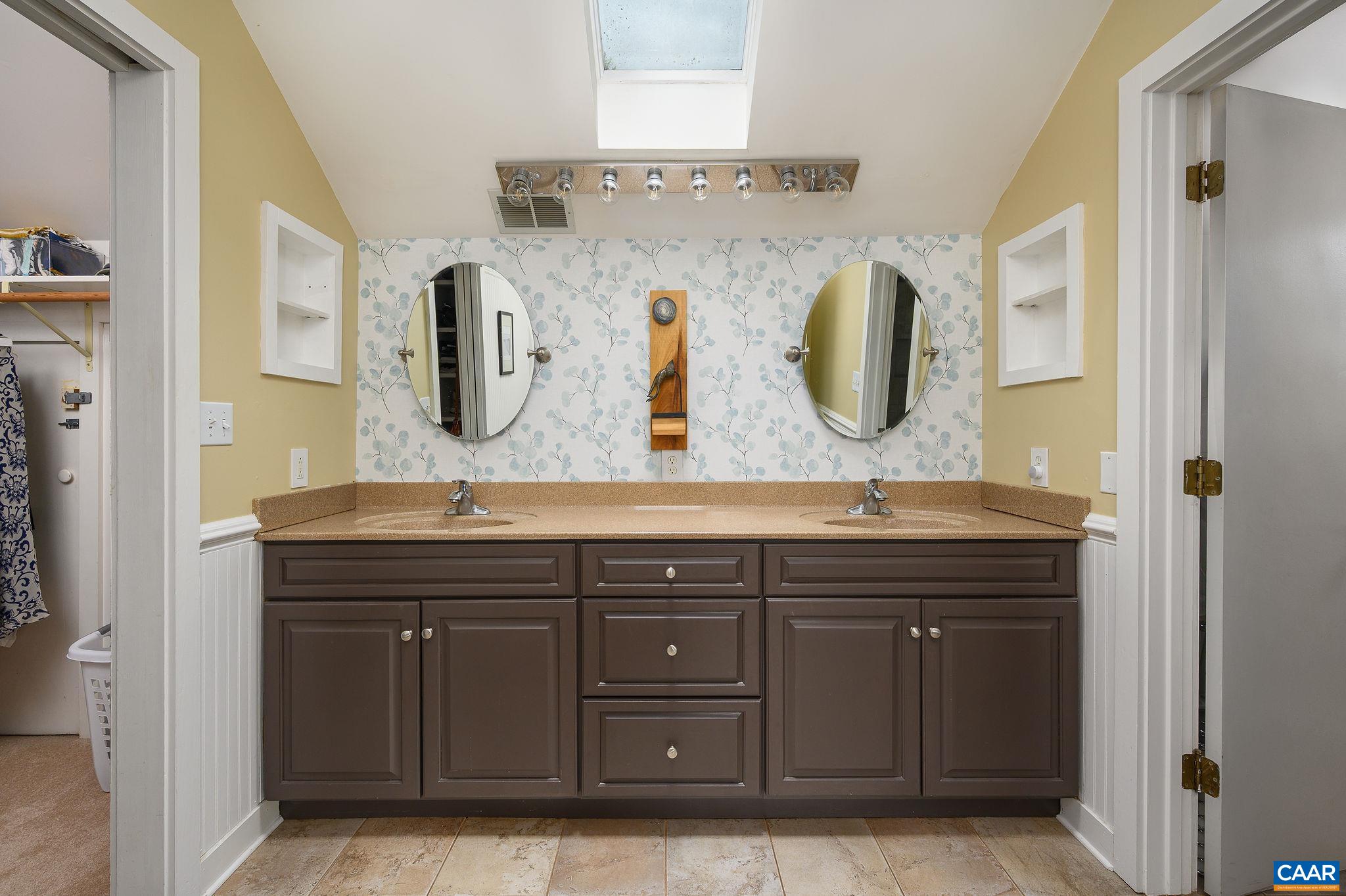 888 Wolf Trap Road Charlottesville, VA 22911 - Photo 21 of 63 a bathroom with a granite countertop sink a mirror and shower
