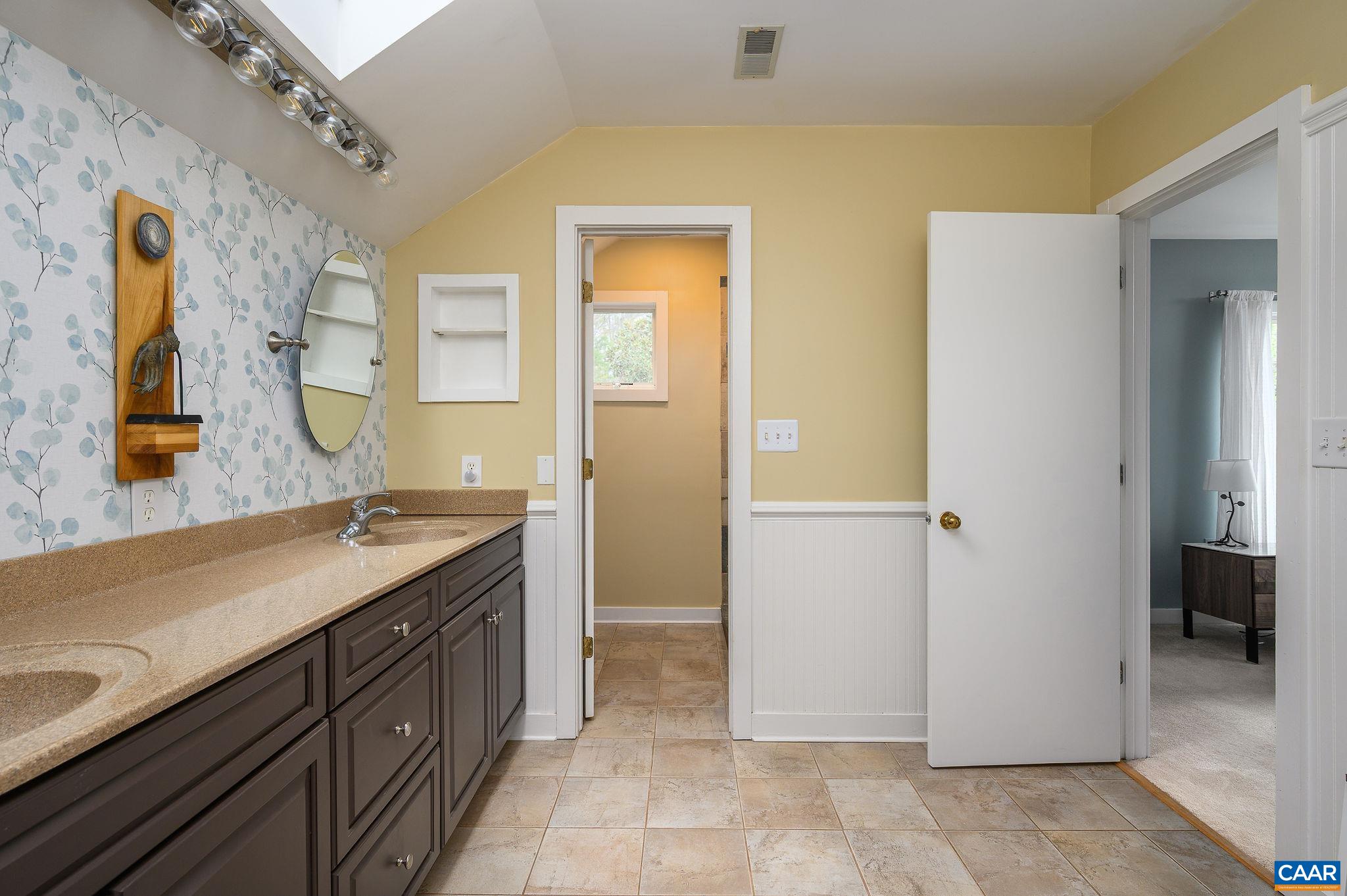 888 Wolf Trap Road Charlottesville, VA 22911 - Photo 22 of 63 a spacious bathroom with a granite countertop sink a mirror and a shower