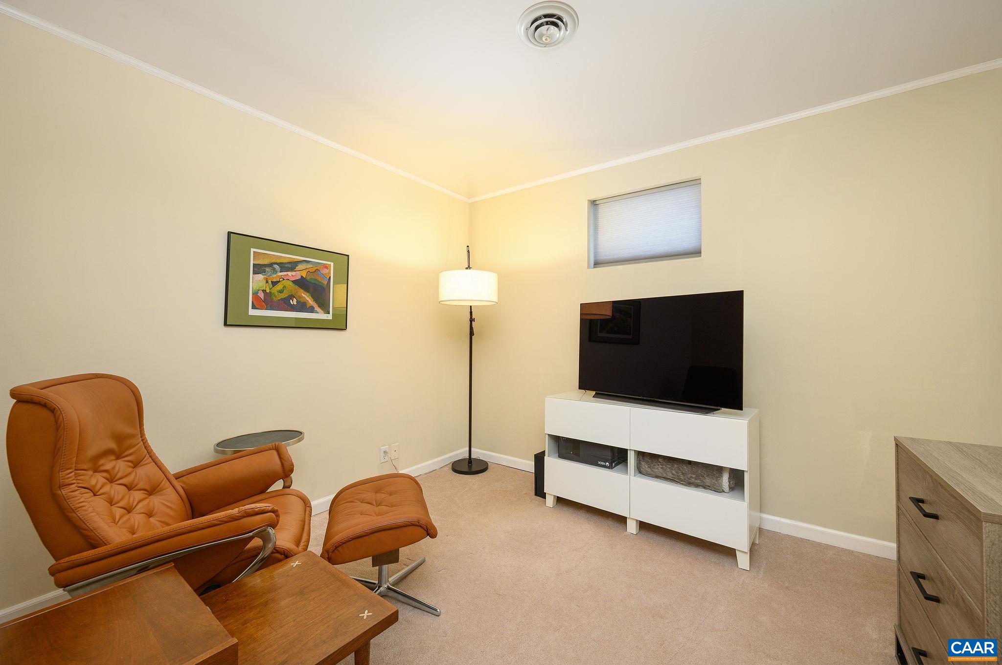 888 Wolf Trap Road Charlottesville, VA 22911 - Photo 33 of 63 a living room with furniture and a flat screen tv