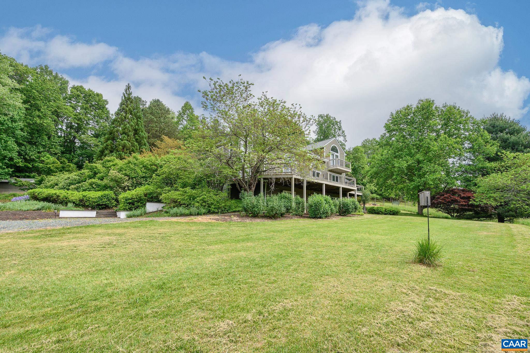 888 Wolf Trap Road Charlottesville, VA 22911 - Photo 36 of 63 a view of a big yard with a house in the background