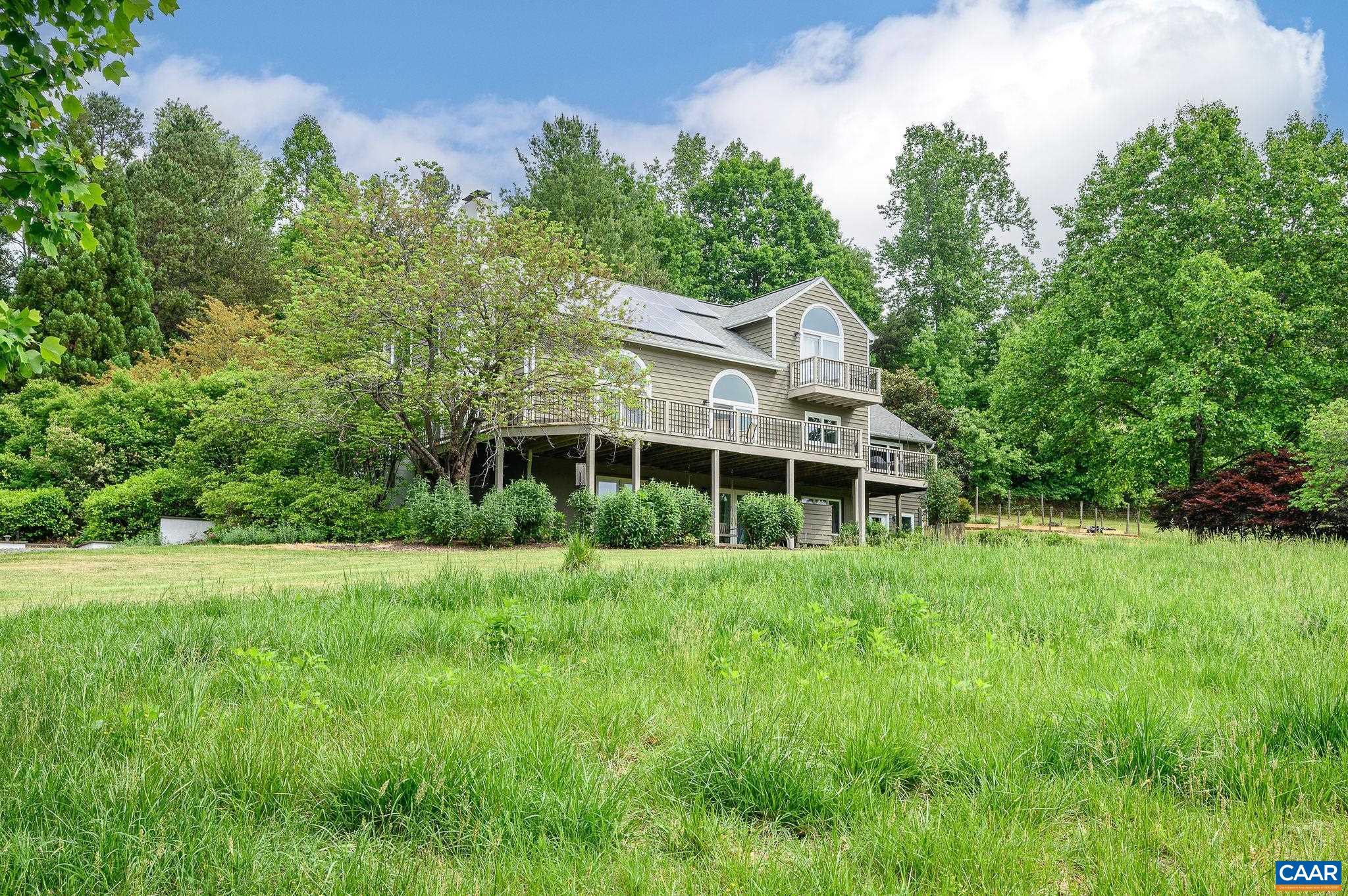888 Wolf Trap Road Charlottesville, VA 22911 - Photo 62 of 63 a view of a big house with a big yard and large trees