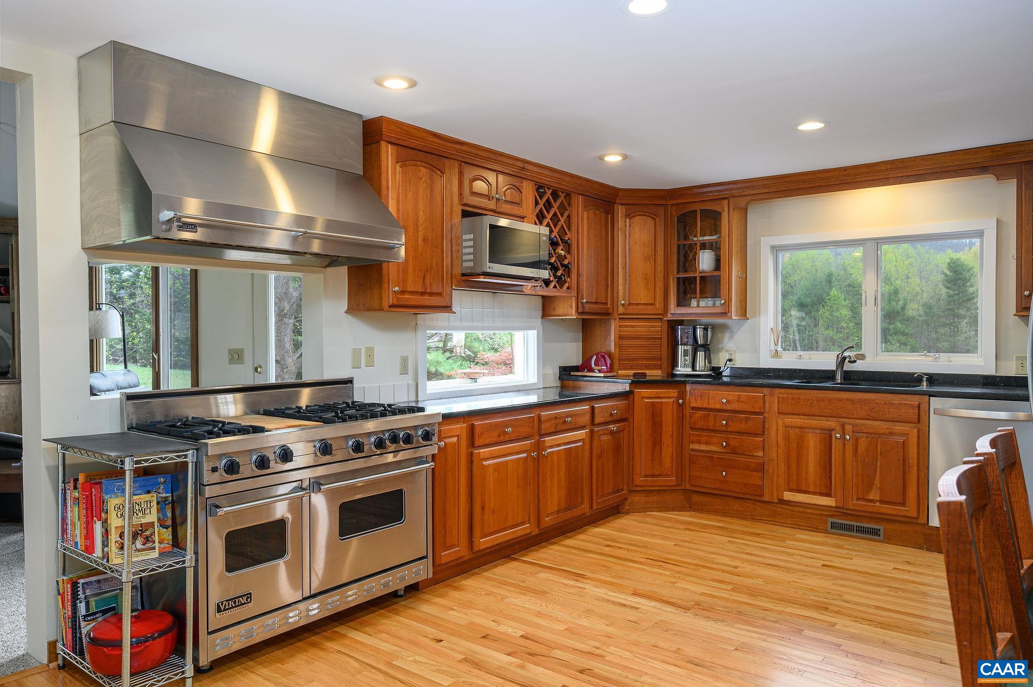 888 Wolf Trap Road Charlottesville, VA 22911 - Photo 10 of 63 a kitchen with stainless steel appliances granite countertop a stove and a sink