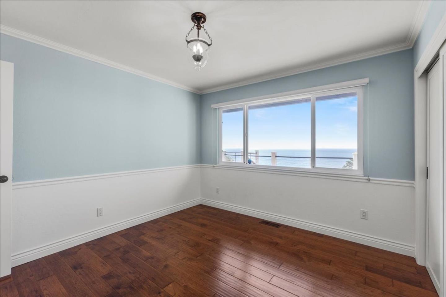 15 Mentone Road Carmel, CA 93923 - Photo 20 of 47 wooden floor in an empty room with a window