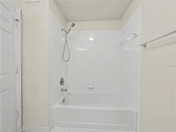 a bathroom with a shower and a bath tub