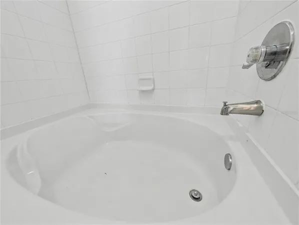 a white bath tub sitting in a bathroom