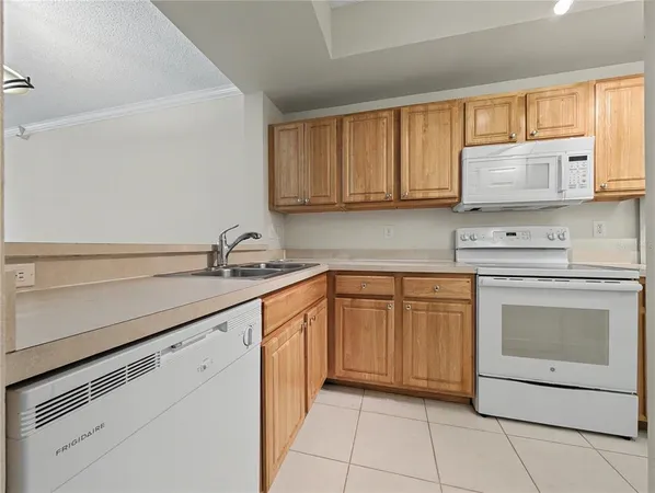 a kitchen with white cabinets sink and stainless steel appliances