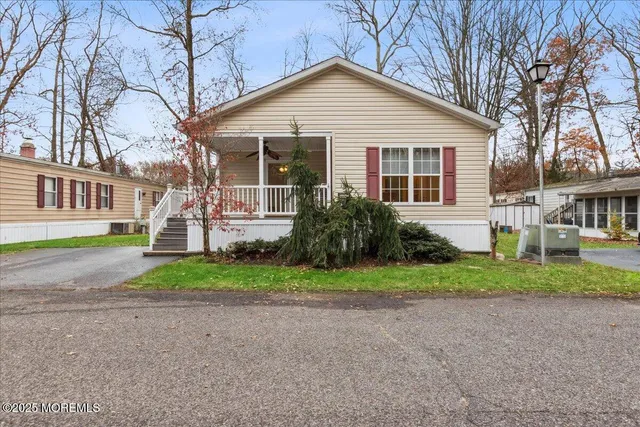 a front view of a house with a yard and porch