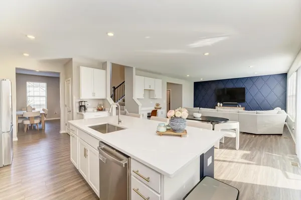 a kitchen with a sink and a stove top oven