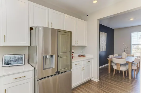 a kitchen with stainless steel appliances a refrigerator and a stove top oven