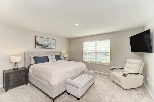 a spacious bedroom with a bed and a couch