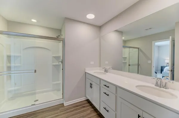 a spacious bathroom with a granite countertop sink mirror and shower