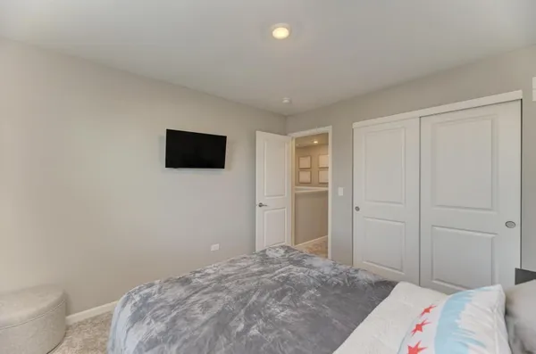 a bedroom with a bed and a tv