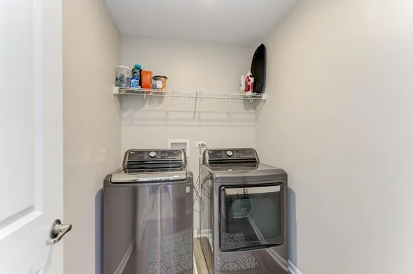 a kitchen with a stove and a wooden floor