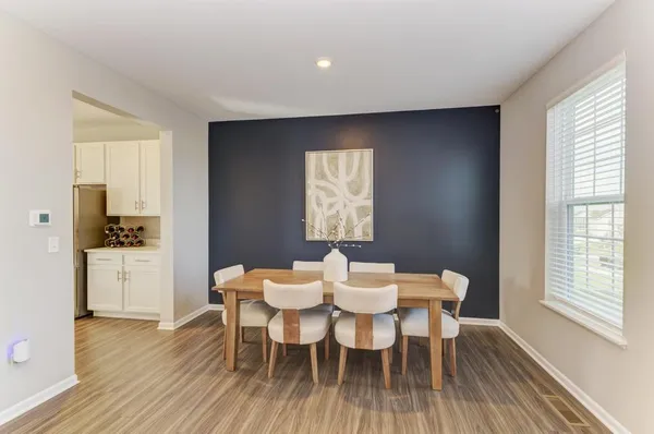 a view of a dining room with furniture and wooden floor