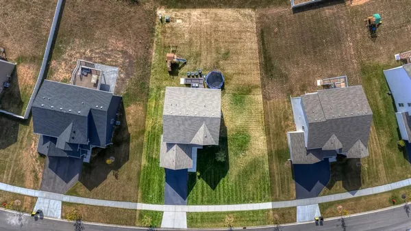 an aerial view of residential houses with outdoor space