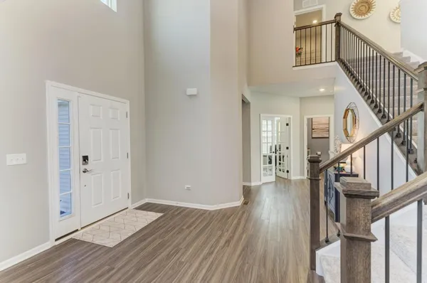 a view of an entryway with wooden floor and stairs