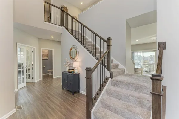 a view of entryway and hall with wooden floor
