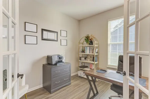 a view of a workspace with furniture and a window