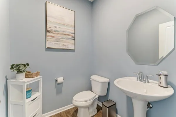 a bathroom with a sink mirror and toilet