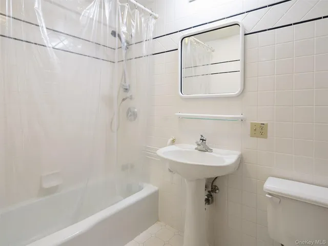 a bathroom with a sink a mirror and a shower