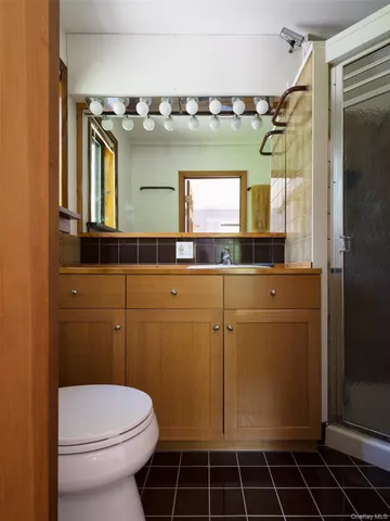 a bathroom with a toilet a sink and mirror