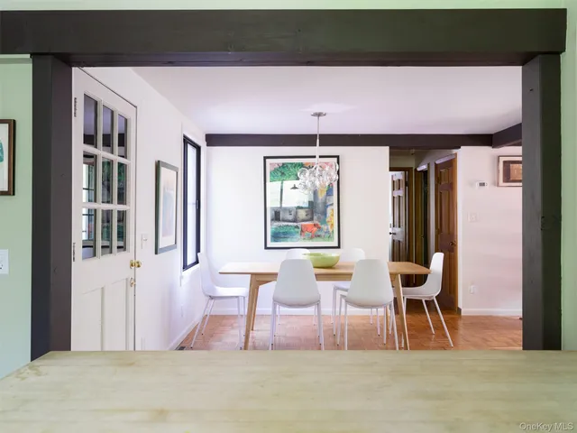 a patio with table and chairs and potted plants