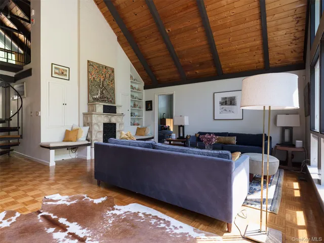 a living room with furniture a flat screen tv and a table