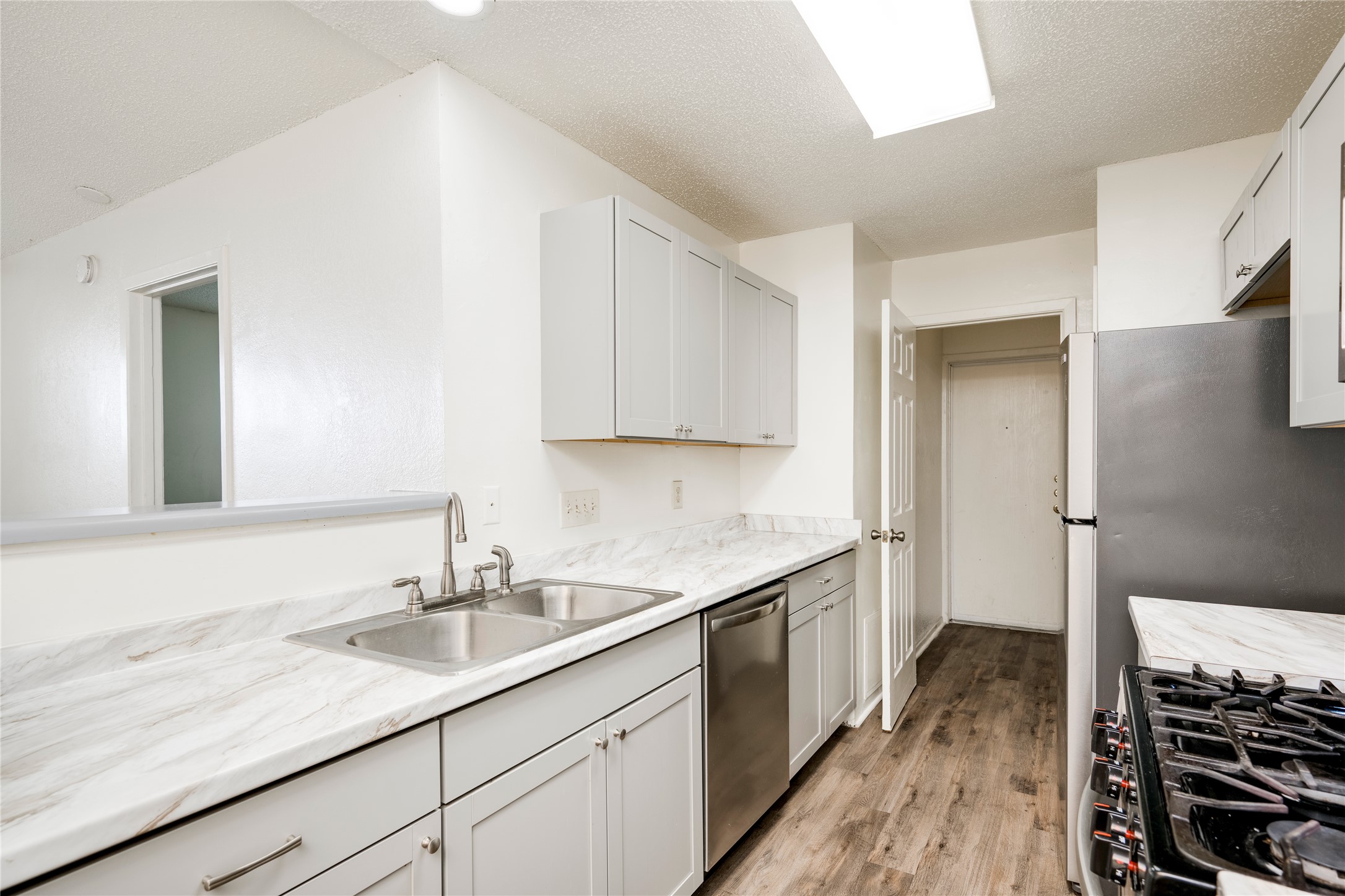 7918 West Gate Boulevard Austin, TX 78745 - Photo 19 of 31 A well-appointed kitchen features ample counter space and modern stainless steel appliances.