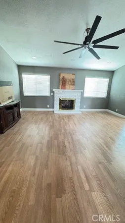 a view of a livingroom with a fireplace and a window