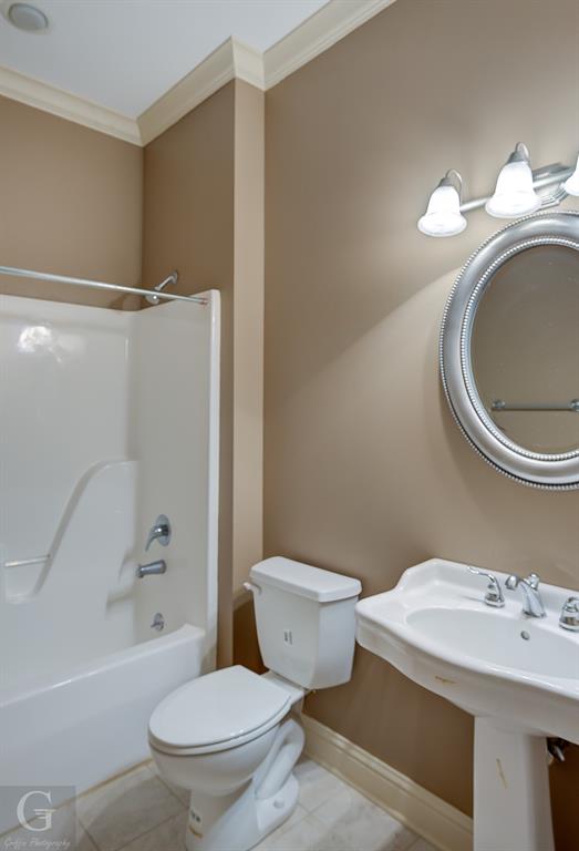 1212 WPA Road Homer, LA 71040 - Photo 18 of 35 Full bath with ornamental molding, toilet, a sink, tile patterned flooring, and baseboards