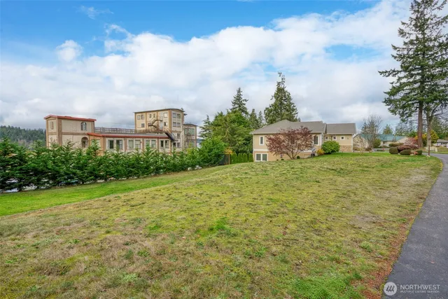 a view of a field with an trees in front of it