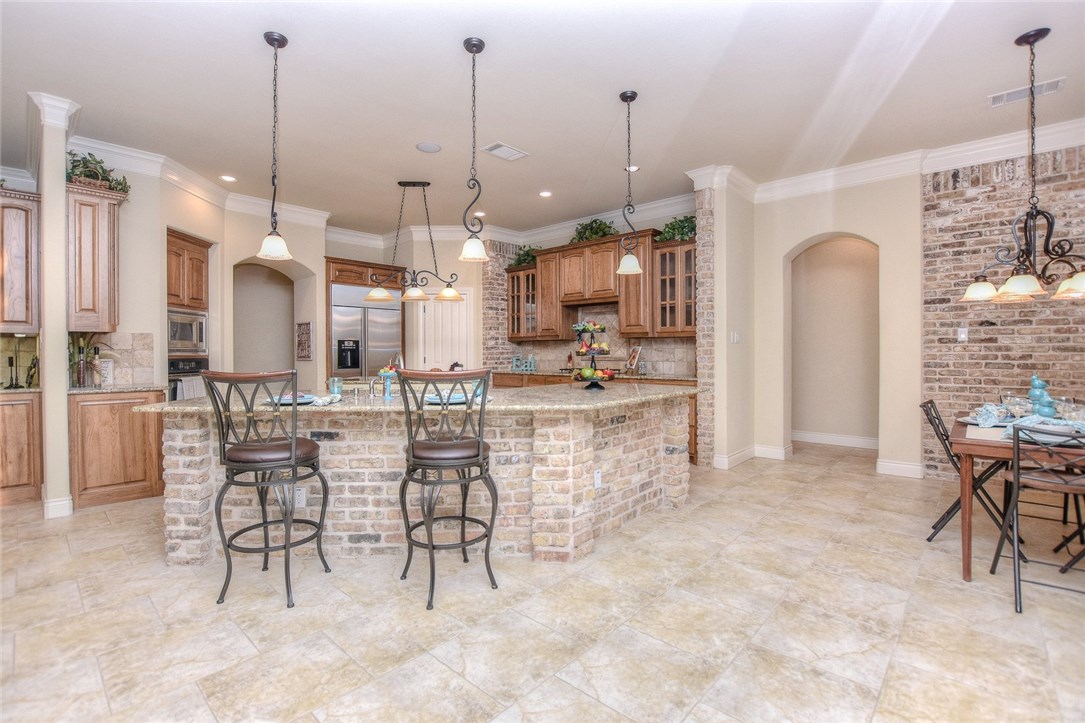 a view of kitchen with furniture and refrigerator