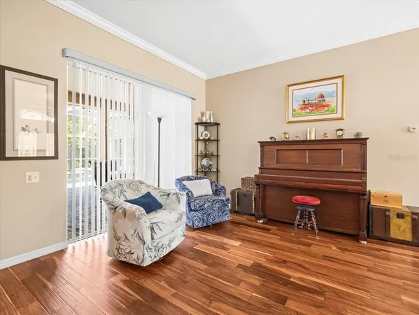 a kitchen with stainless steel appliances granite countertop a stove top oven a sink a dining table and chairs with wooden floor